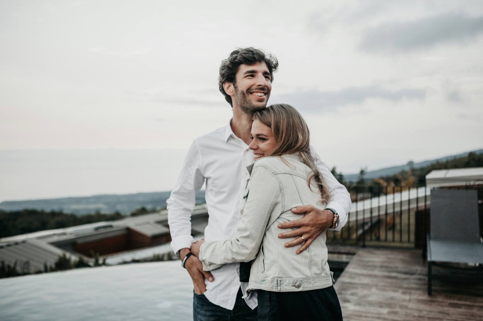 A smiling couple embracing outdoors